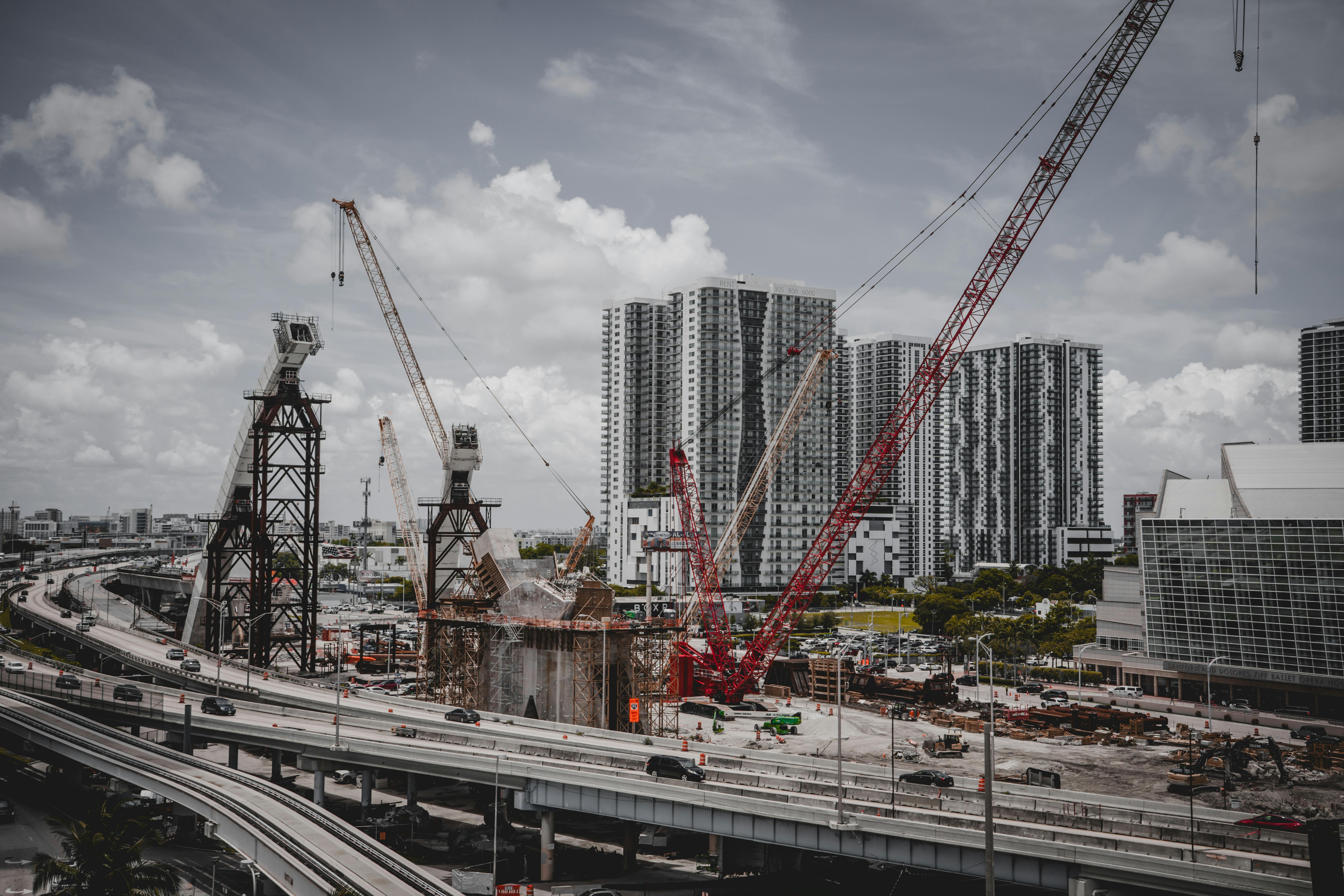Large-scale commercial construction site in Texas with cranes and structural steel